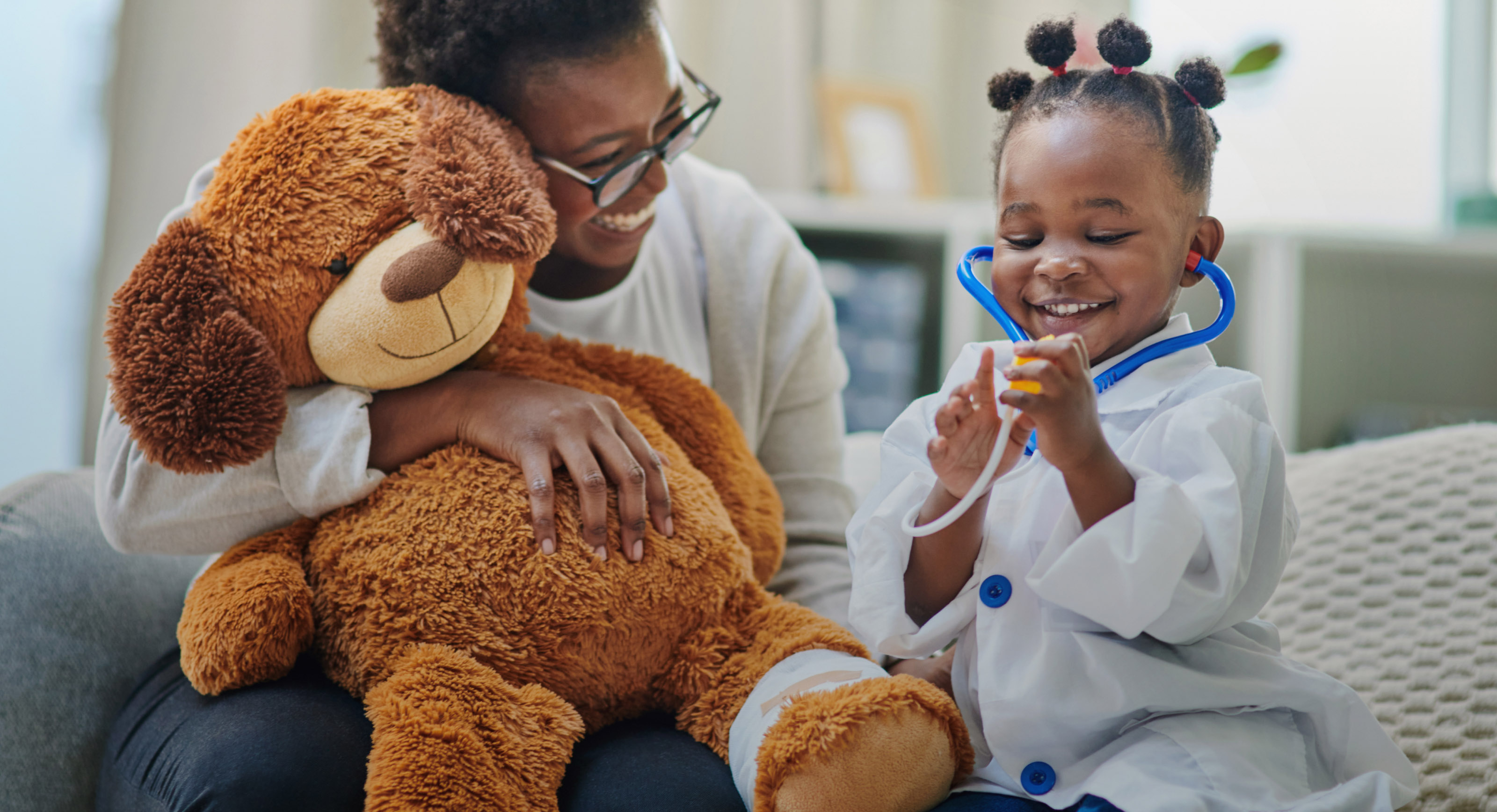 Physician with pediatric patient and stuffed bear